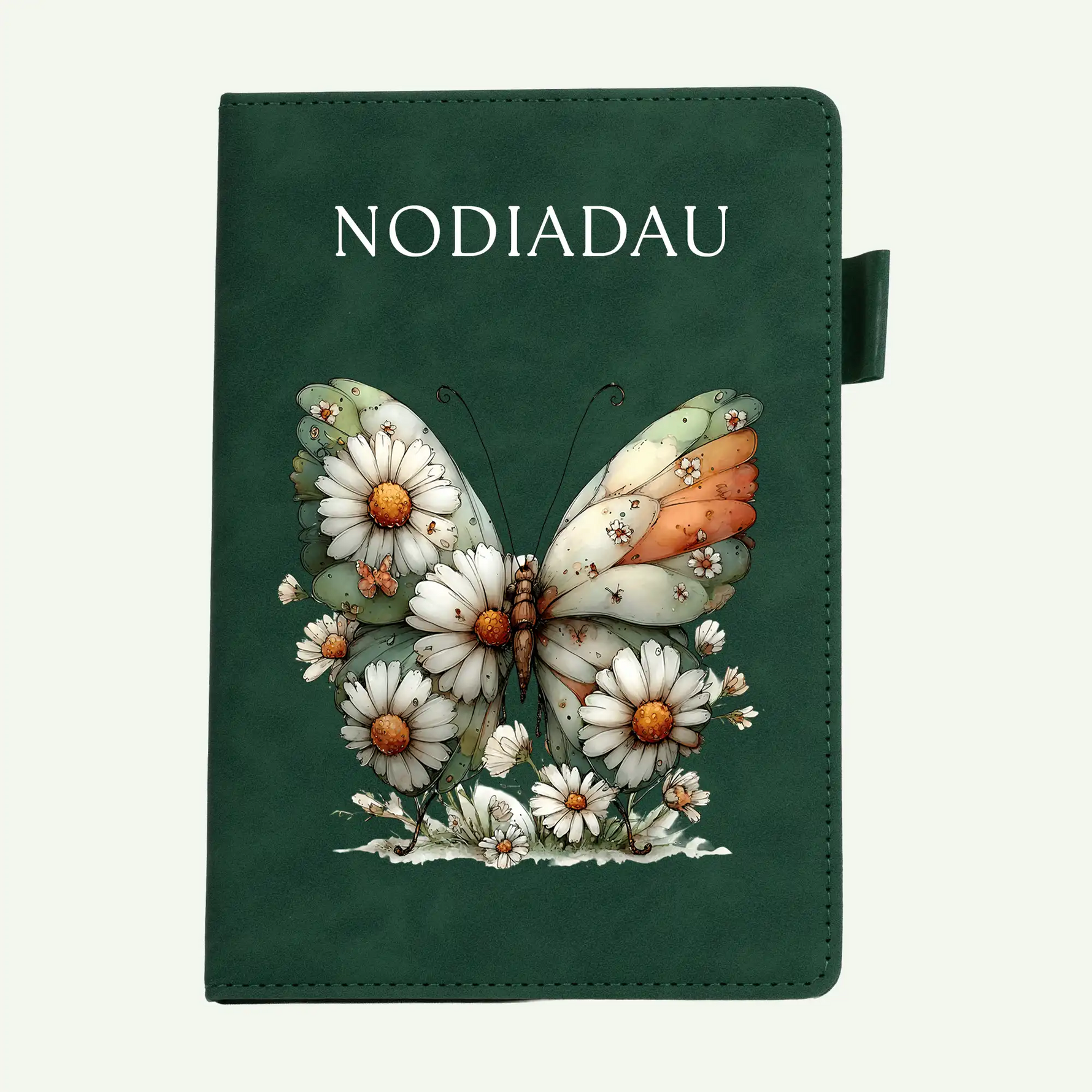 A dark green notebook or journal with the word 'NODIADAU' printed at the top and an illustrated butterfly surrounded by white daisies on the front cover, shown against a light off-white background.