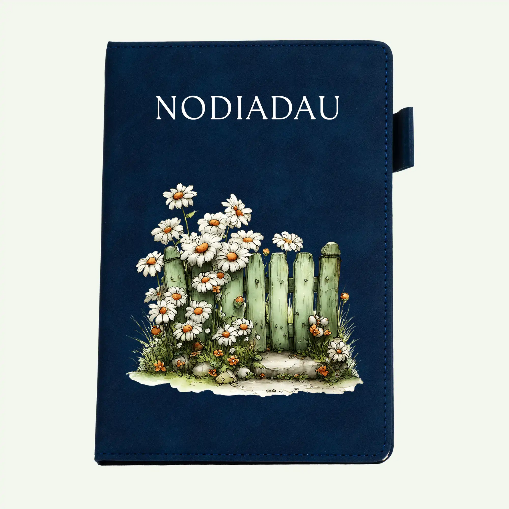 A dark navy blue notebook with a decorative illustration of white daisies, green cacti, and small orange flowers on the front cover, with the word 'NOTEBOOK' printed at the top.